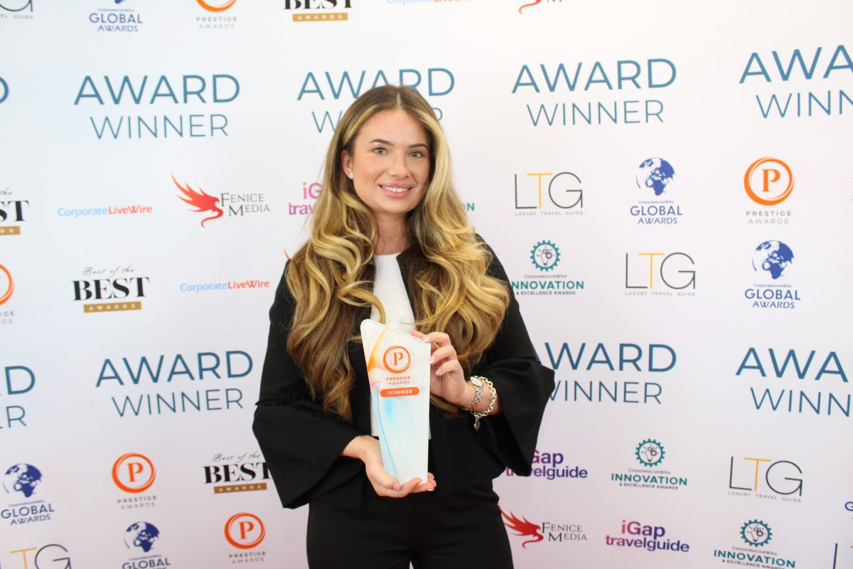 Rosie from Rosemary Events & Catering receiving a Prestige Awards winner trophy